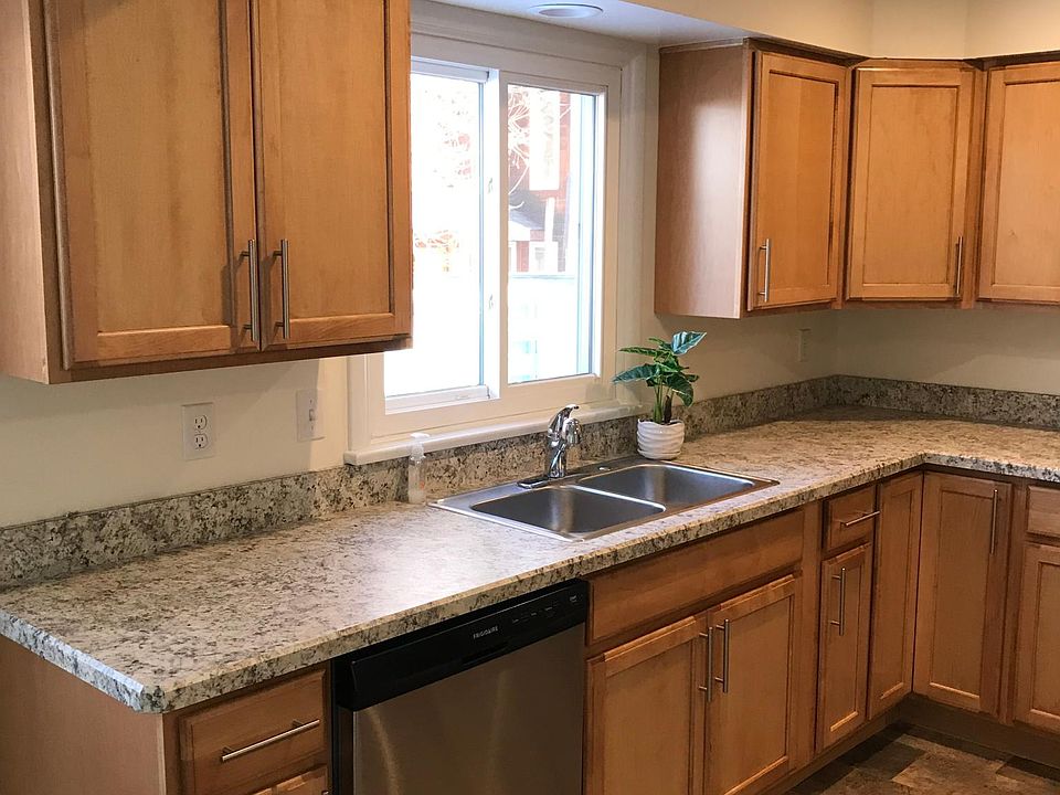 Kitchen with new custom cabinets, new countertops and flooring, stainless dishwasher, recessed lighting.