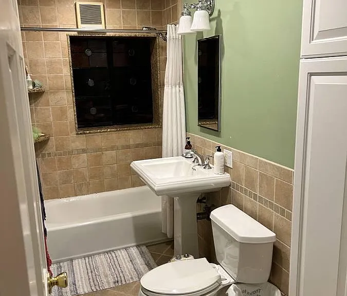 Bathroom (medicine cabinet/mirror over sink; floor-to-ceiling storage cabinet on right)