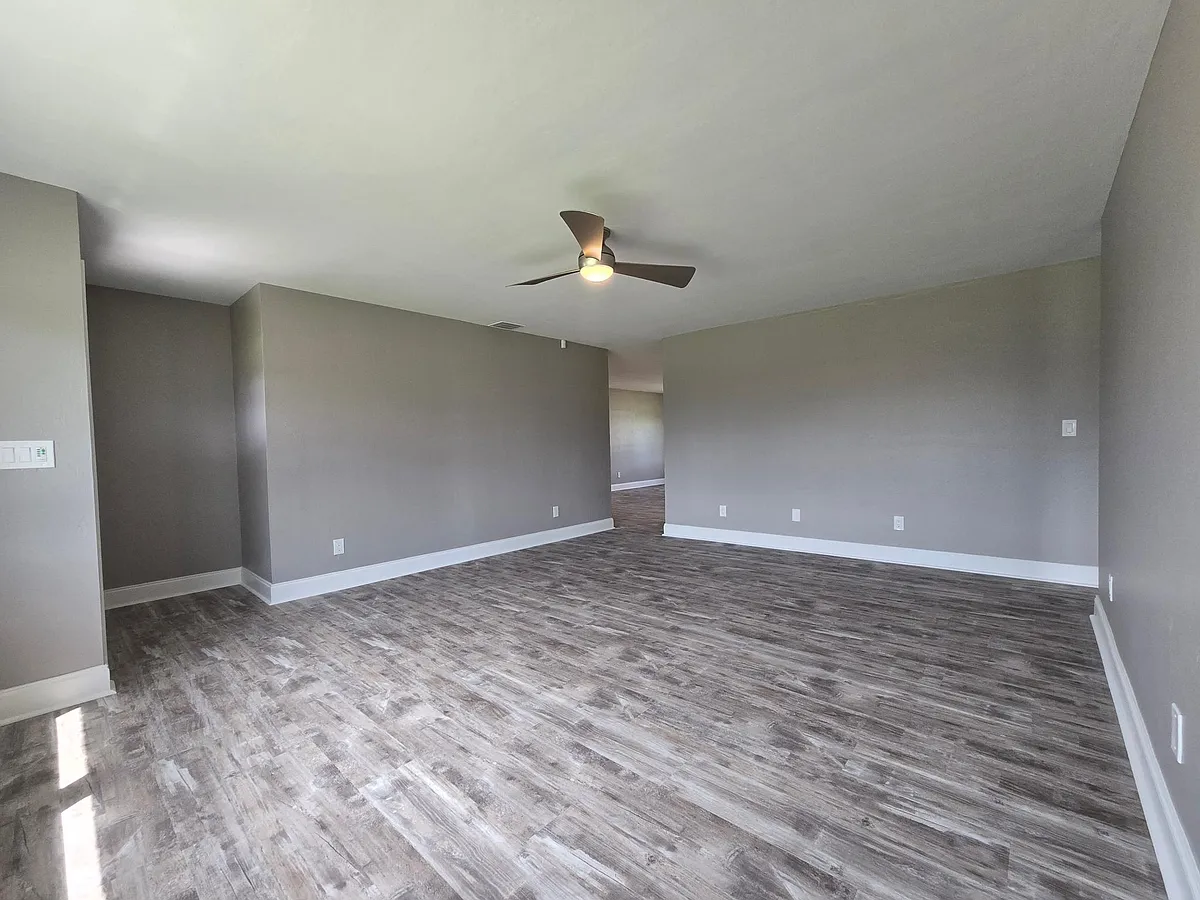 Large living room with brand new luxury planking floors and all new paint. - 12668 3rd St