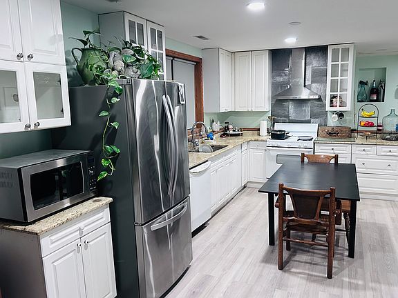 Kitchen on level 1 with new refrigerator. *Microwave not included.
