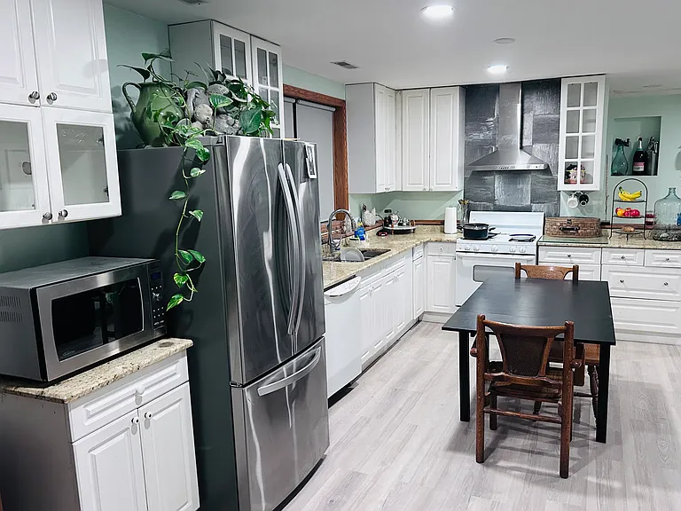 Kitchen on level 1 with new refrigerator. *Microwave not included.