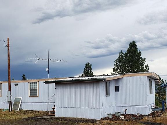 Outside, front view shows covered, front porch addition.