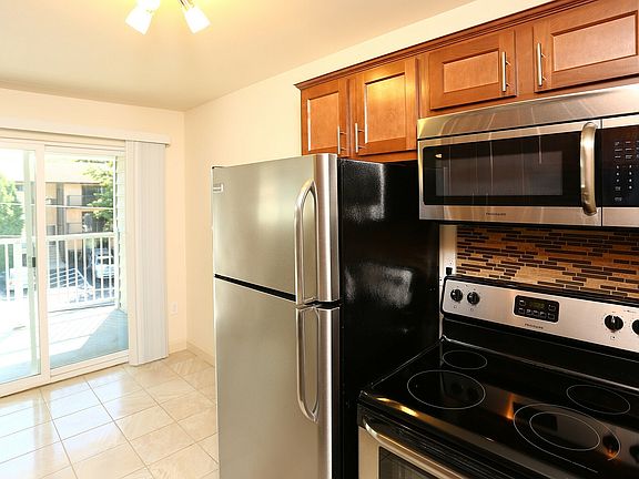 Explore this sleek, modern kitchen featuring top-of-the-line stainless steel appliances.