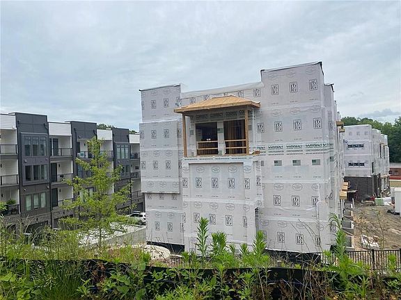 Standing on the Southeast Beltline trail looking at the unit. Covered porch sits RIGHT on the trail.