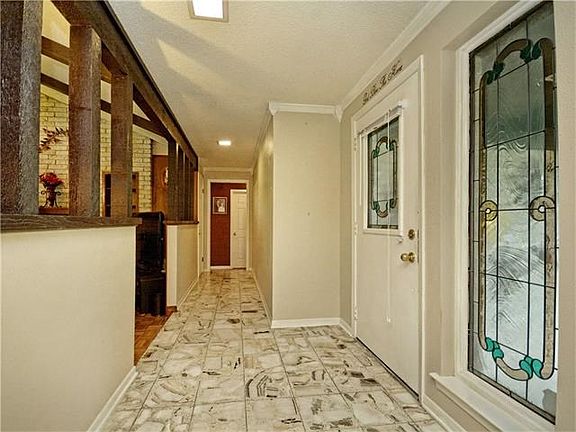Large open and bright entryway. Stained glass windows.