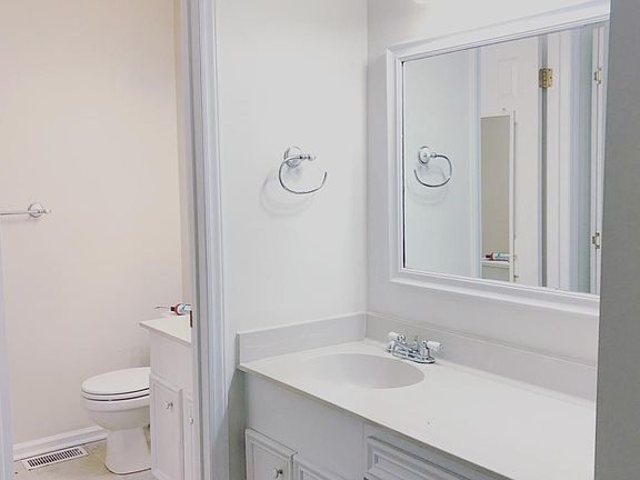 Master bath equipped with vanity sink and fill bath set up in the other section.