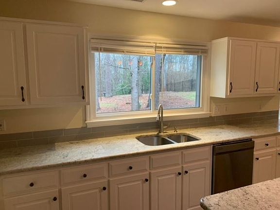Kitchen, dual sink w/ view to fenced backyard