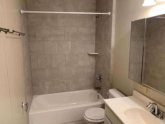 Tile surrounded steel tub and tile floor.