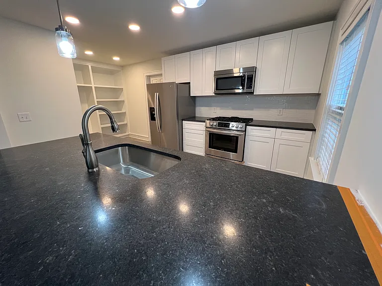 Another view of the kitchen with pantry to the left