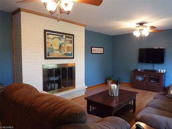 Formal Living room with hardwood floors and wood burning fireplace.
