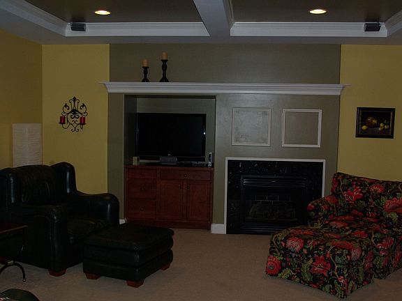 Family Room with coffered ceilings and built in entertainment area & fireplace