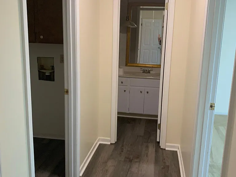 Hallway to the laundry room, two bedrooms, and bathroom.