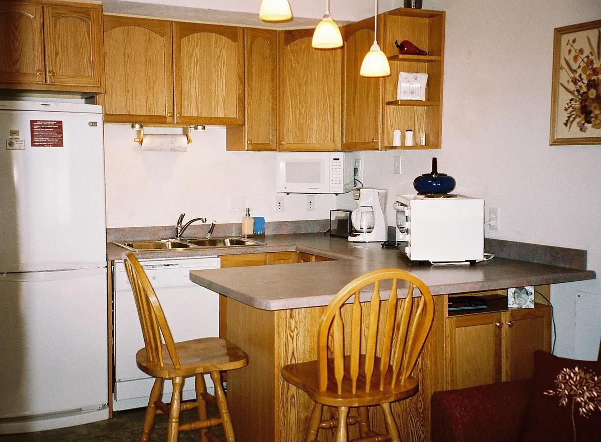Kitchenette. Light fixture has been replaced with ceiling fan with lights, which adds to your comfort. - E La Bonte St
