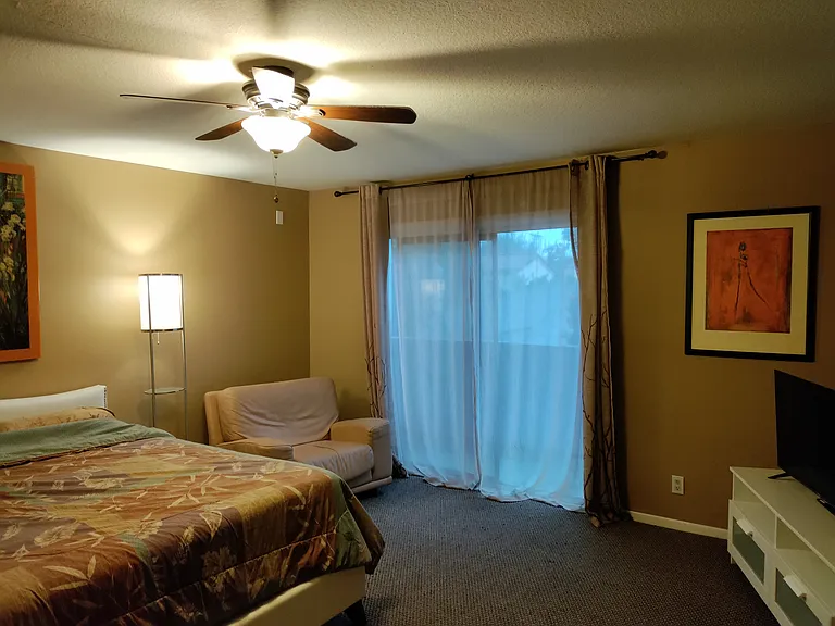 Upstairs back bedroom with private balcony.