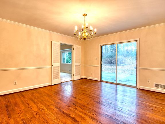 Dining room with patio access to wooded backyard