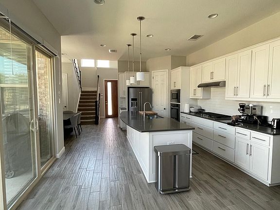 Fully furnished kitchen with gas range and spacious storage