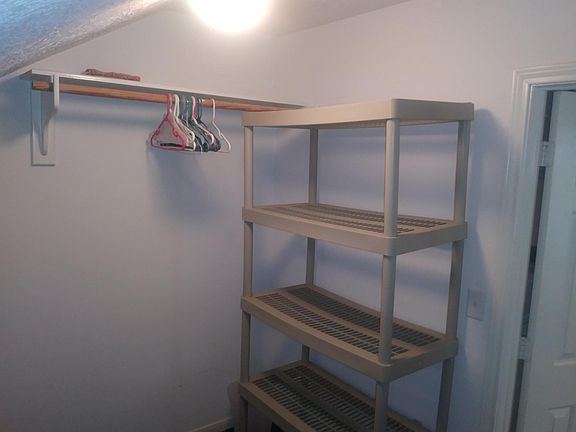 Big walk in closet with storage.