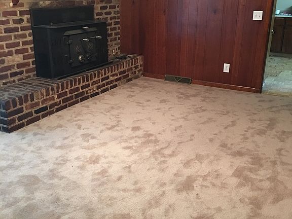 Family room with brick fireplace with wood stove