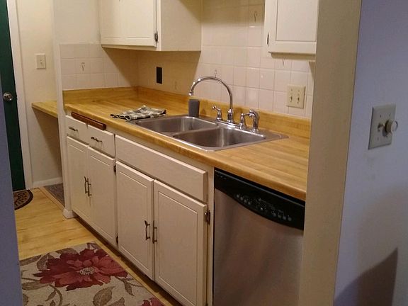 Cream painted cupboards and stainless steel dishwasher.