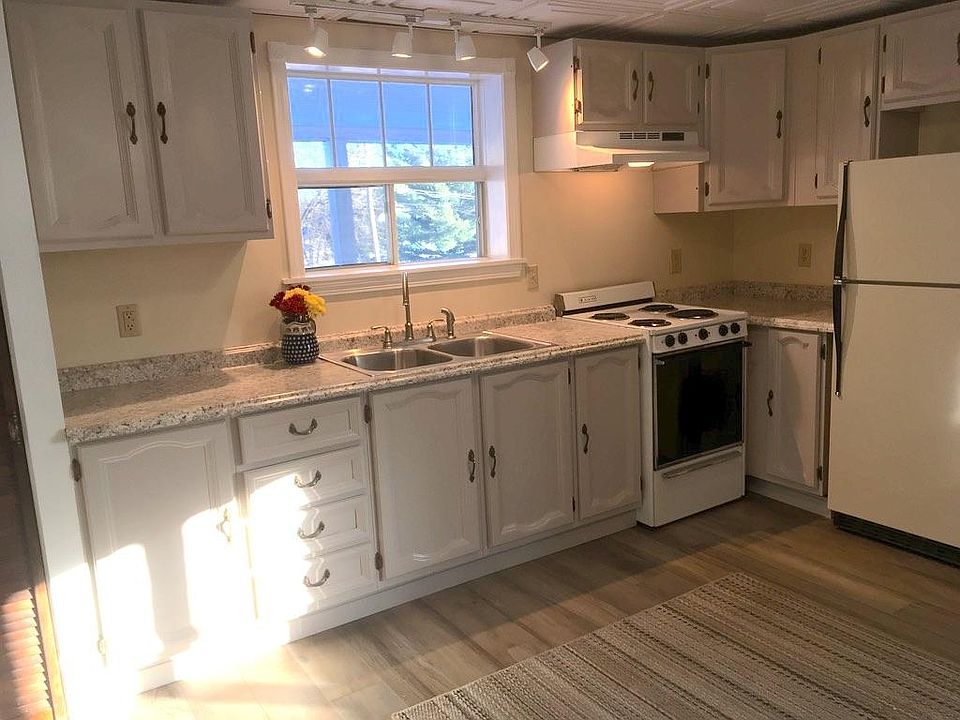 The kitchen has new countertops, new sink and faucet, and plenty of lighting, including an east-facing window.
