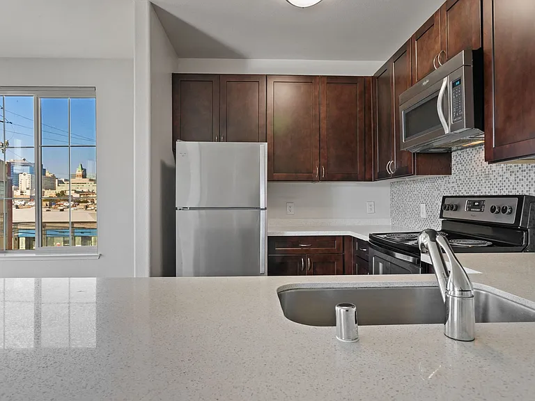 Kitchens are complete with quartz countertops and tiled backsplashes