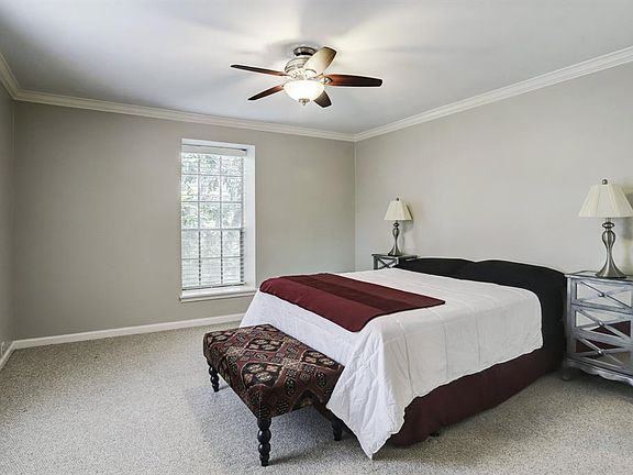 Spacious bedroom with two large windows and ceiling fan. En suite bathroom and huge walk in closet.
