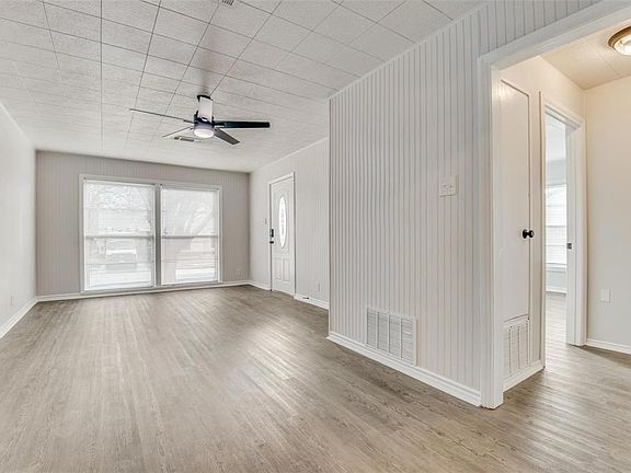 Unfurnished living room featuring light wood-type flooring and a ceiling fan