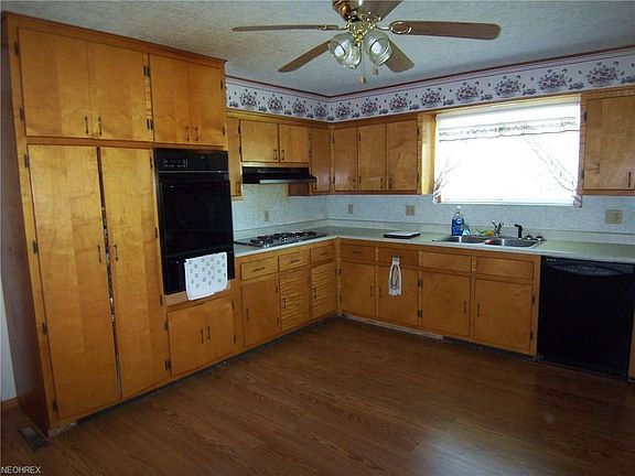 Kitchen has lots of cabinets and counter space.