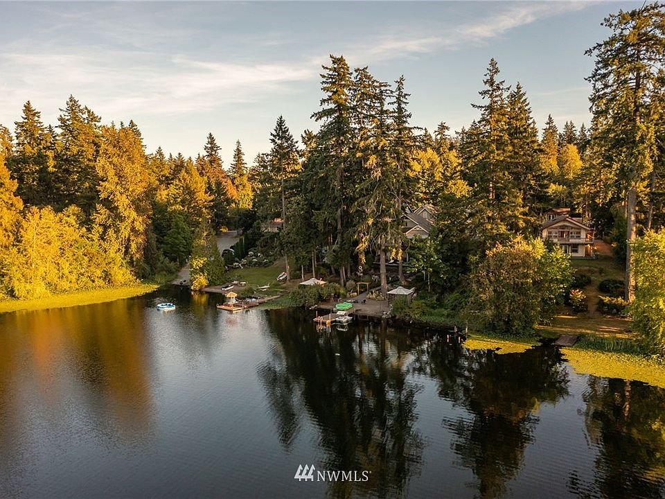 Private setting on .64 acre lot that gently slopes down to 60 ft of no bank waterfront