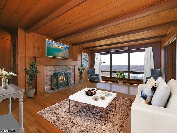 LIVING ROOM WITH RUSTIC TONES LAKE STYLE WITH LAKE VIEWS