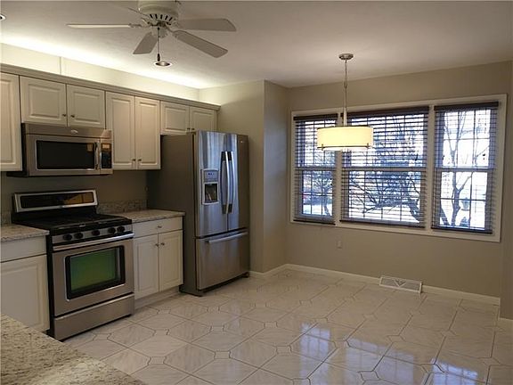 The eat-in-kitchen has been tastefully updated with new granite counter tops and stainless steel appliances.