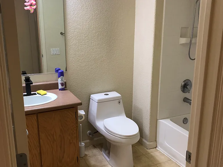 Full bathroom located down the hallway across from Bedroom 1 next to Bedroom 2.