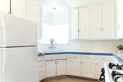 Sunny kitchen with corner window.  Tile counters are in great shape!