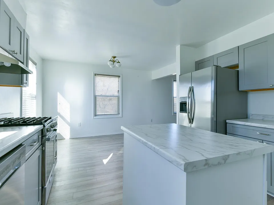 Kitchen with large island, upgraded counter tops and cabinets, and newer appliances