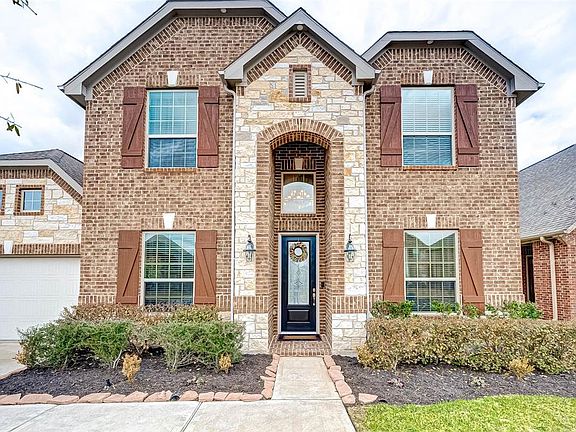 Closer view of home showing the intricate brick and stone work. It offers so much character to this home located at the sought-out community of Long Meadow Farms!