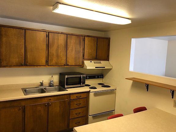 Kitchen with fridge, stove and microwave