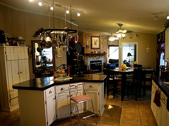 View from Laundry Room of the Large Island in Open Kitchen & on through to the 1st Living Area.