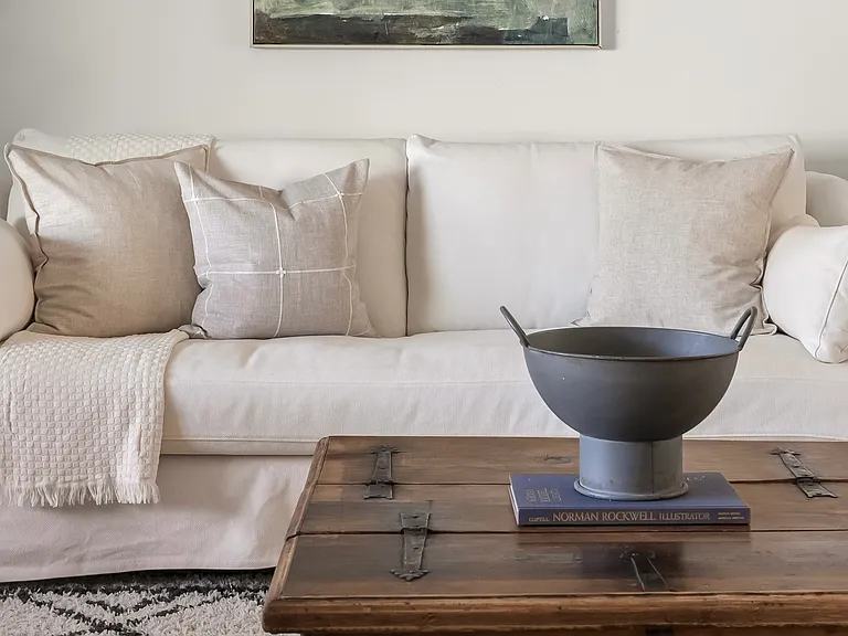 Comfortable living room with generous seating and natural light that opens up to the dining area.