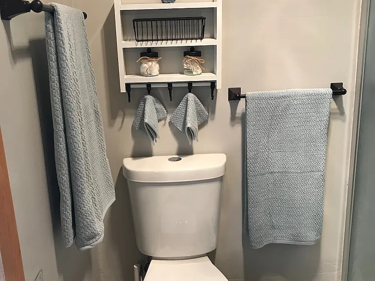 Low flush toilet, comes with 2 full sets of towels, bathmats and rugs, Q-tips, cotton balls and TP to start you off.