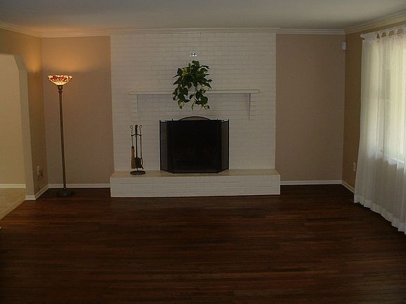 Spacious Living Room has Hardwood Floors and Fireplace