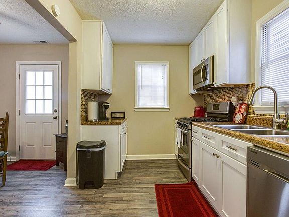 Kitchen looking to back door and dining area