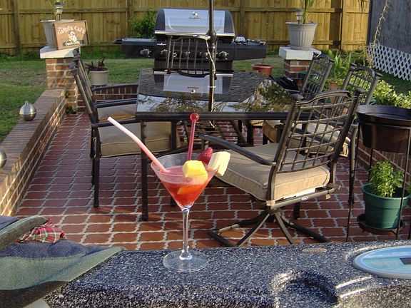 Large tiled patio with dining, and bbq area