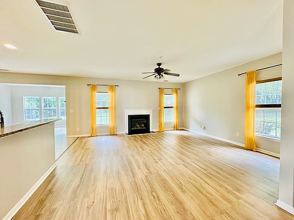 Open floor family room with ample natural light from windows