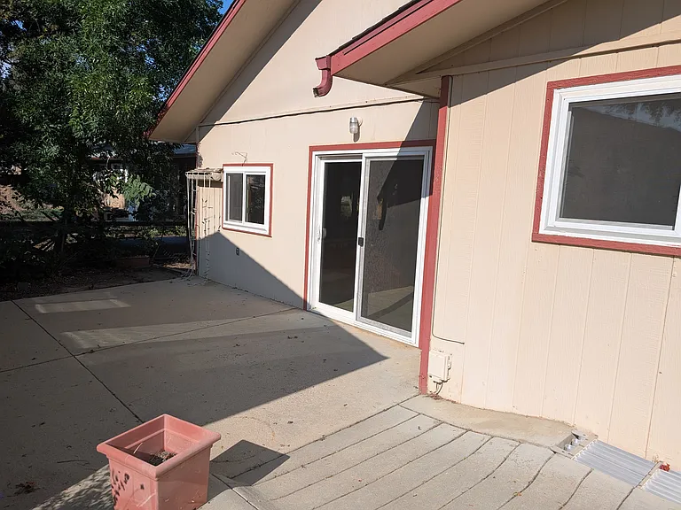 back yard sliding glass doors from hot tub room to back 2 car garage, back yard and shed
