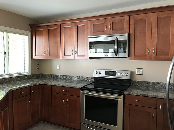 Brand new kitchen featuring stainless steel appliance and gr