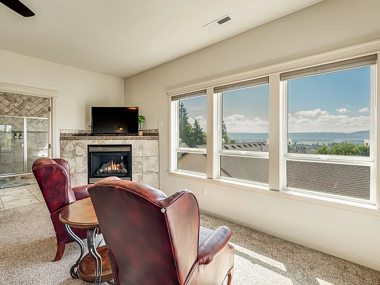Lots of space in the large primary suite, featuring a walk-in closet, seating area, and dream worthy view