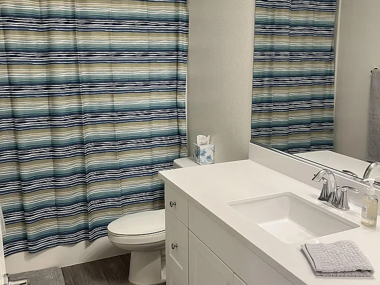 Full bathroom with a tub/shower combo, wide vanity with storage, and a large mirror for easy daily routines.