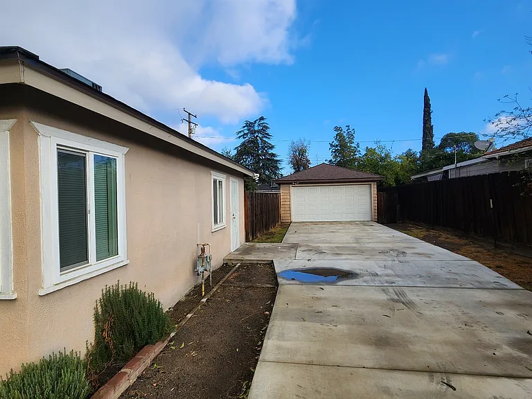 Long driveway to detached 2-car garage.