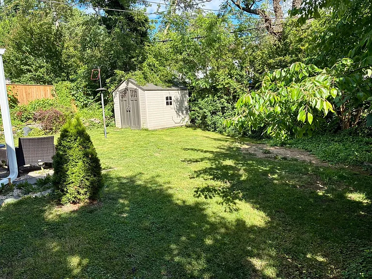 Backyard; lots of landscaping including flowering shrubs, fig tree, etc. that is not shown. Former owner was avid gardener.
