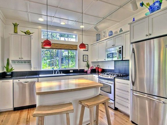 The modern kitchen drenched in natural light. There's plenty of preparation and storage space for th